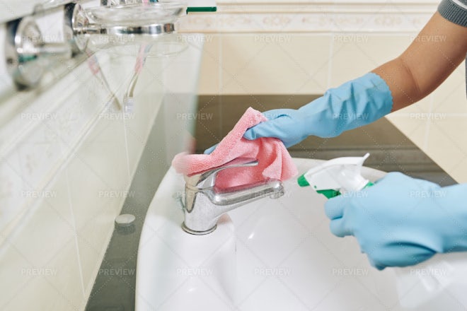 Housewife cleaning table Stock Photo by DragonImages