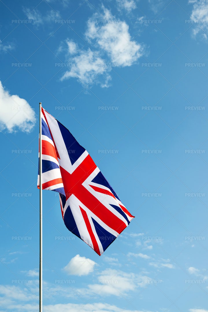 UK Flag In Blue Sky Vertical: Stock Photos