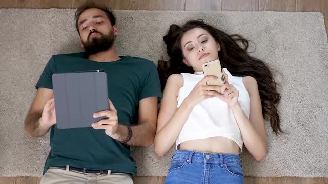 Couple Lying Down On Floor: Stock Video