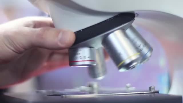 Male Scientist Handling A Microscope: Stock Video