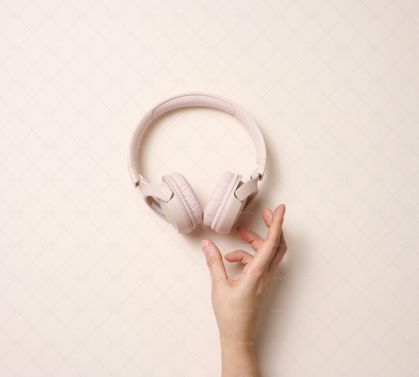 Hand Hold Pink Wireless Headphone: Stock Photos