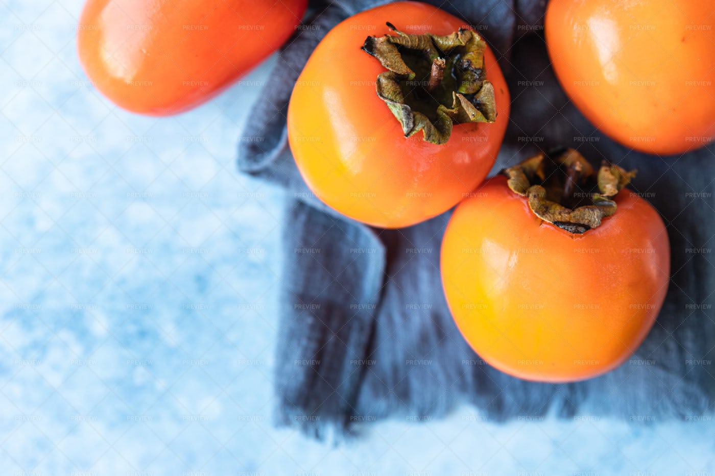 Fresh Organic Ripe Persimmons On Blue: Stock Photos