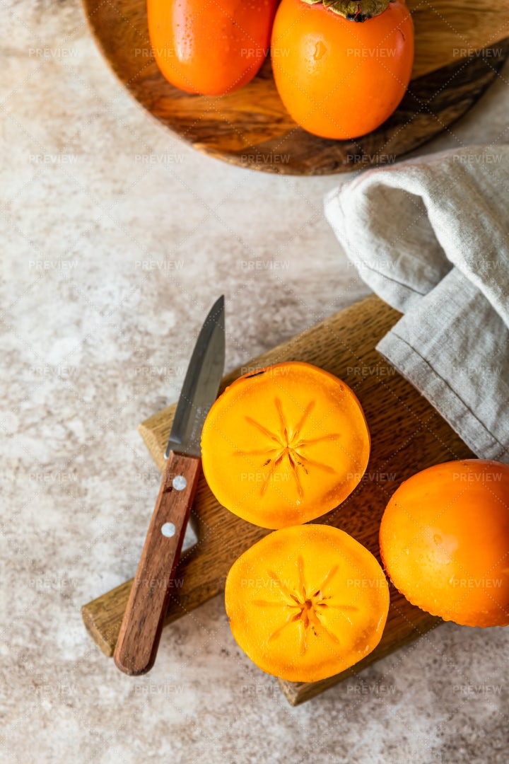 Whole And Cut Half Ripe Orange Persimmon: Stock Photos