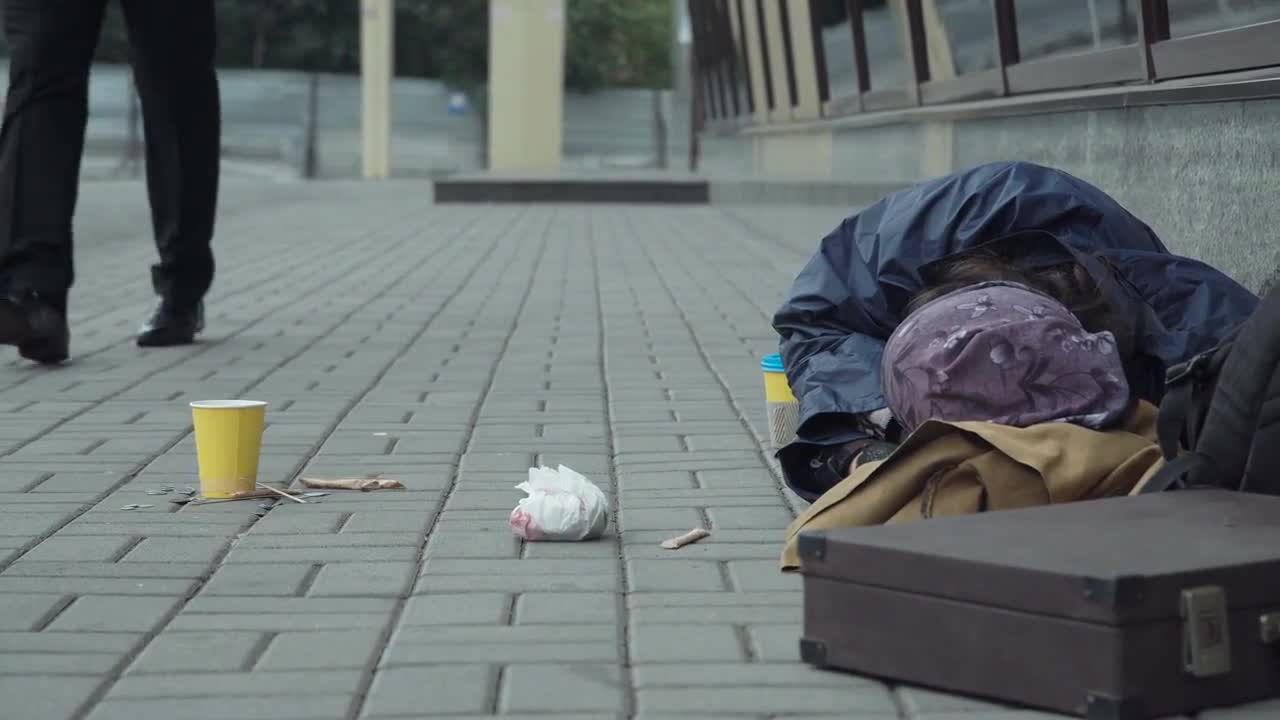 Man Gives Money To Beggar - Stock Video | Motion Array