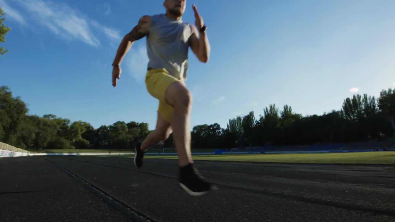 Man Sprinting On Race Track - Stock Video | Motion Array