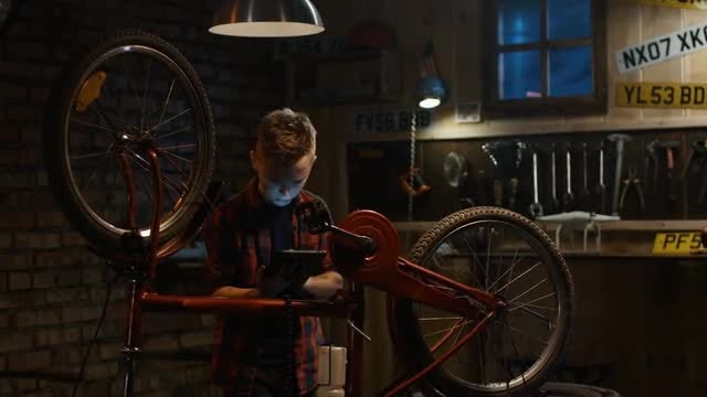 Boy Learns To Repair Bike: Stock Video