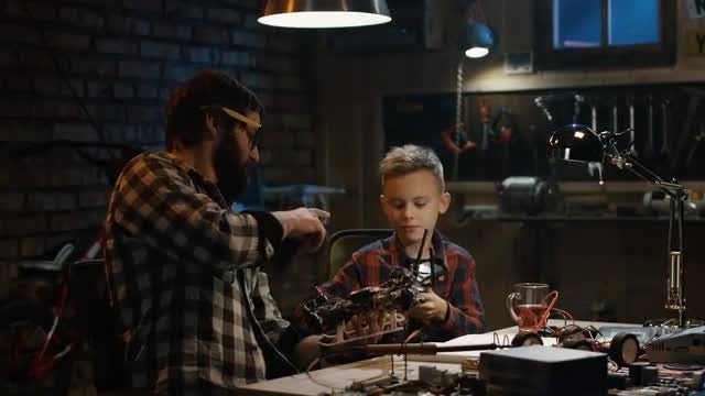 Father And Son Repair Drone: Stock Video