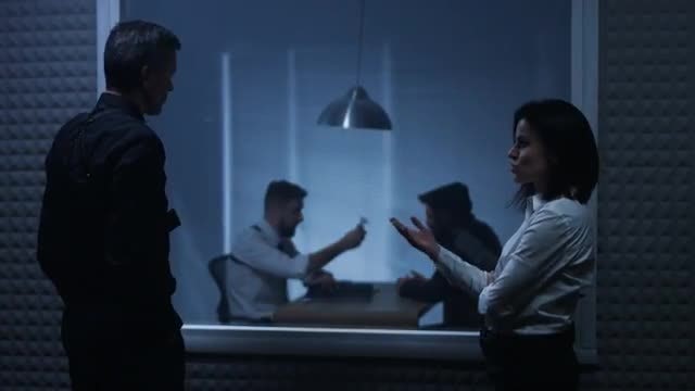 Detectives Watch Interrogation: Stock Video