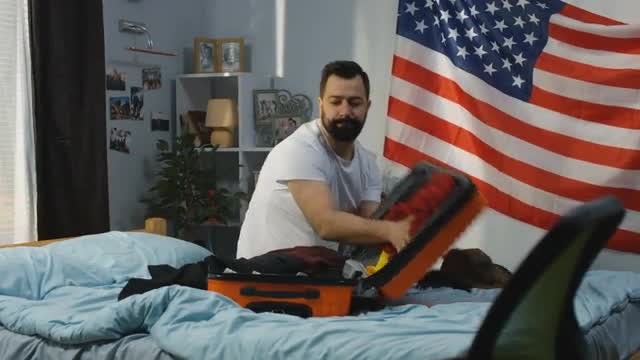 American Man Packing Suitcase: Stock Video
