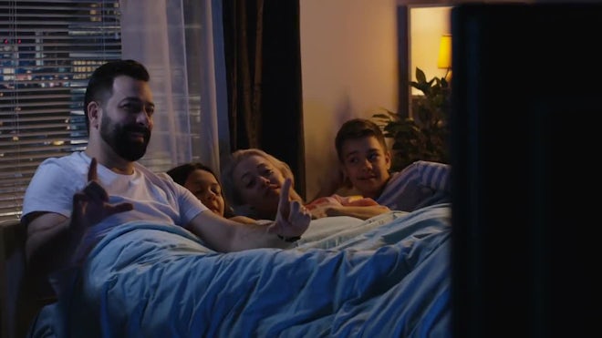 family watching tv together at night