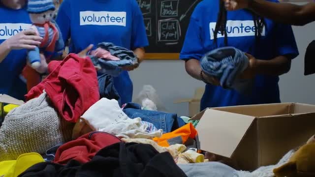 Volunteers Sort Donations: Stock Video