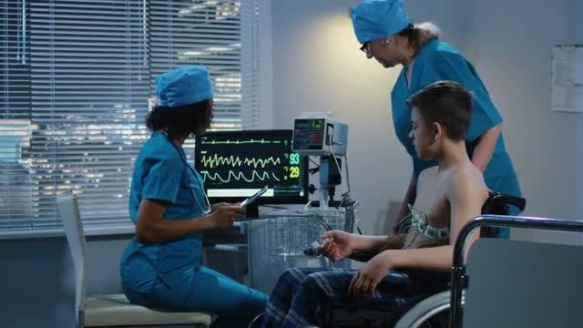Doctors Examining Teen Patient: Stock Video