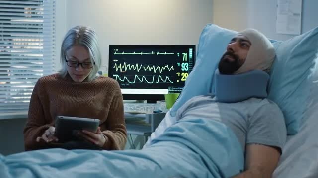 Woman Reading Notes To Patient: Stock Video