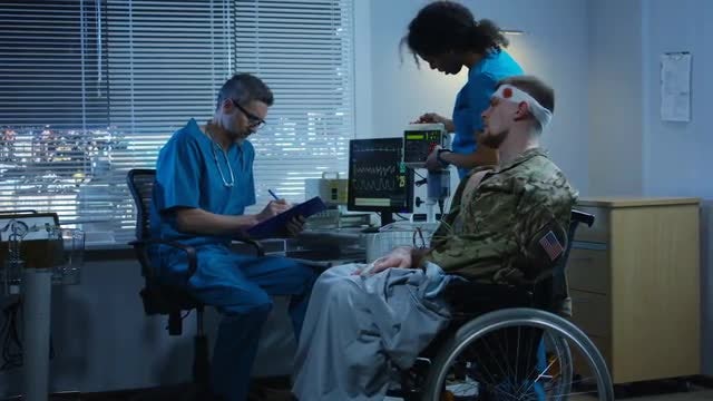 Doctors Diagnosing Injured Solider: Stock Video