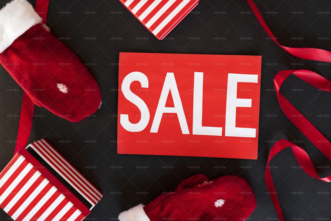 Santa's Red Warm Mittens And Sale Sign: Stock Photos