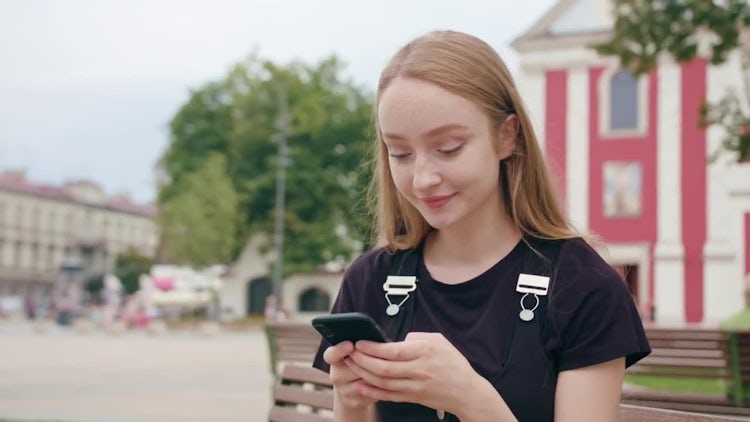 Girl Chatting On Her Smartphone: Stock Video