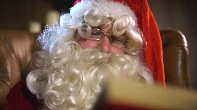 Santa Claus Reminisces With Book: Stock Video