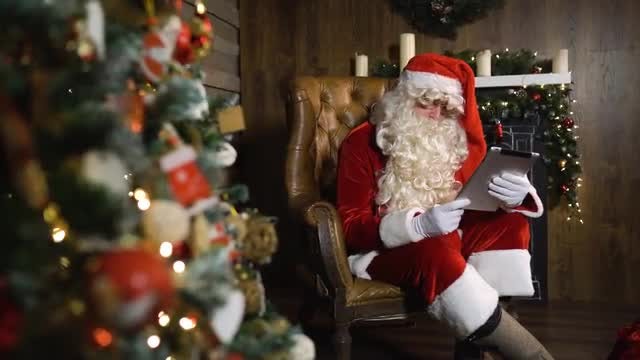 Santa Claus Working Using Tablet: Stock Video