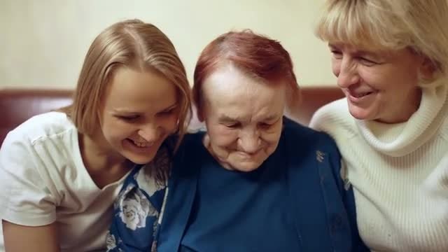 Three Generations Look Through Photos: Stock Video