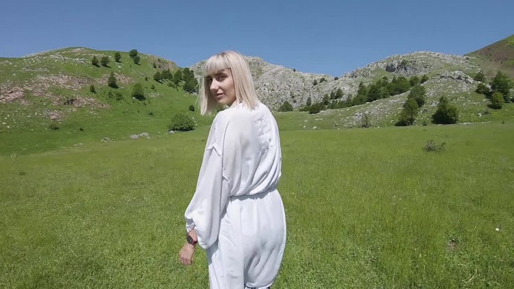 Woman Walking On A Meadow: Stock Video