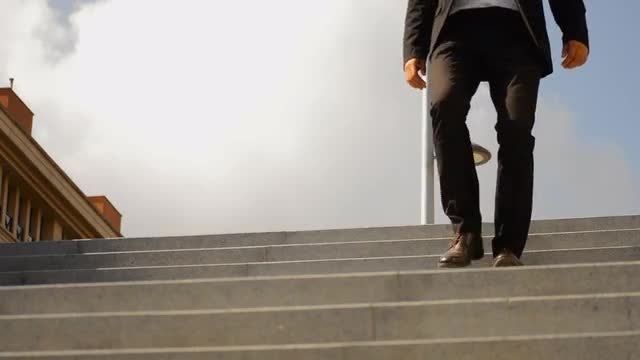 Businessman Walking Down The Stairs: Stock Video