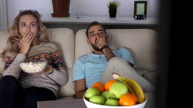 Young Couple Watching Horror Movie: Stock Video