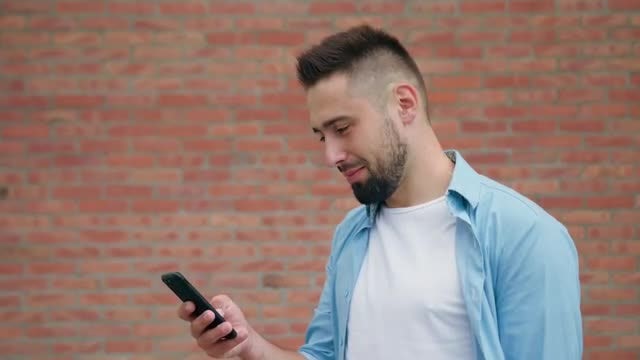 Happy Man Scrolling On Smartphone: Stock Video