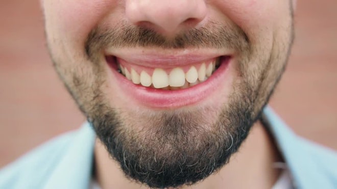 A CLOSE UP of a man smiling menacingly, , Stock Video