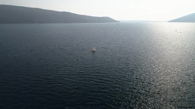 Boat Sailing Along Mesmerizing Seascape: Stock Video