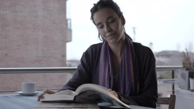 Woman Reading and Drinking Coffee: Stock Video