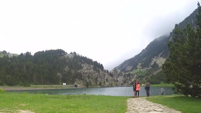 Hikers Walking By The Lake: Stock Video