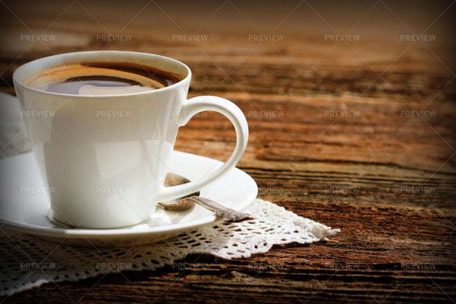 Close up white coffee cup with heart shape latte art on wood table at cafe  - Shamrock Foods