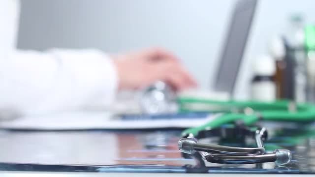 Doctor Typing On A Laptop: Stock Video