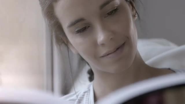 Woman Reading By Window: Stock Video