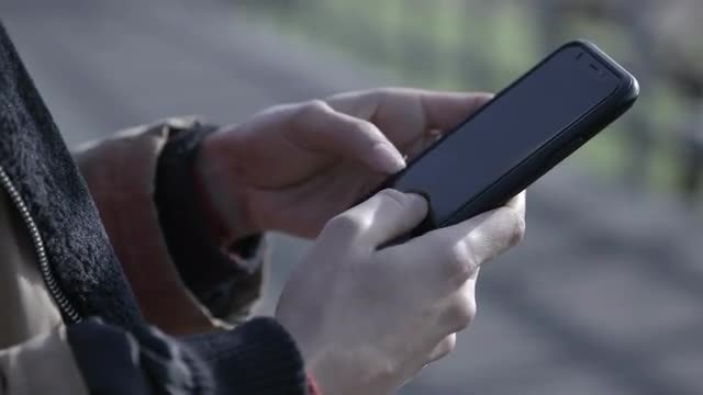 Woman Texting On A Smartphone: Stock Video