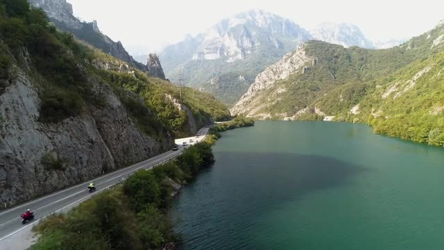 Vehicles Cruise Through Canyon Road: Stock Video