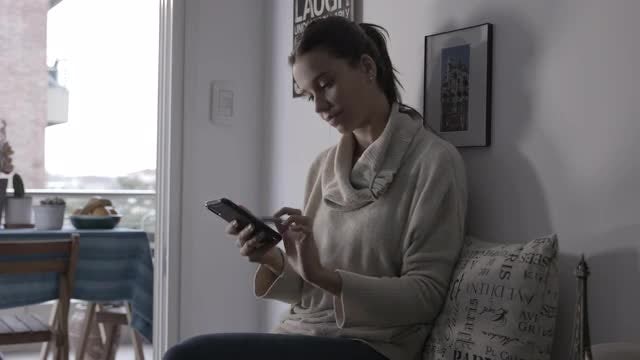 Woman Using Smartphone At Home: Stock Video