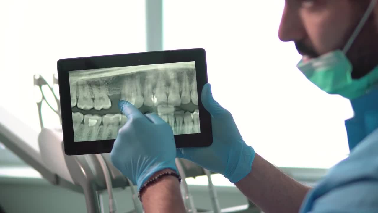 Dentist Discusses X-Ray On Tablet - Stock Video | Motion Array