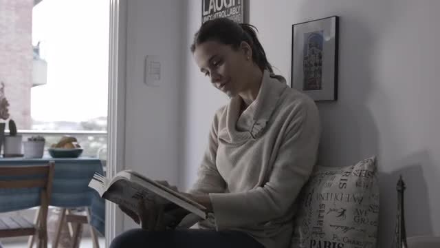 Woman Reading Book At Home: Stock Video
