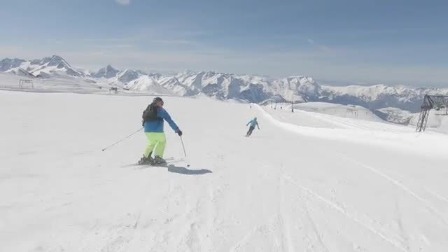 Two Skiers Descending A Mountain: Stock Video