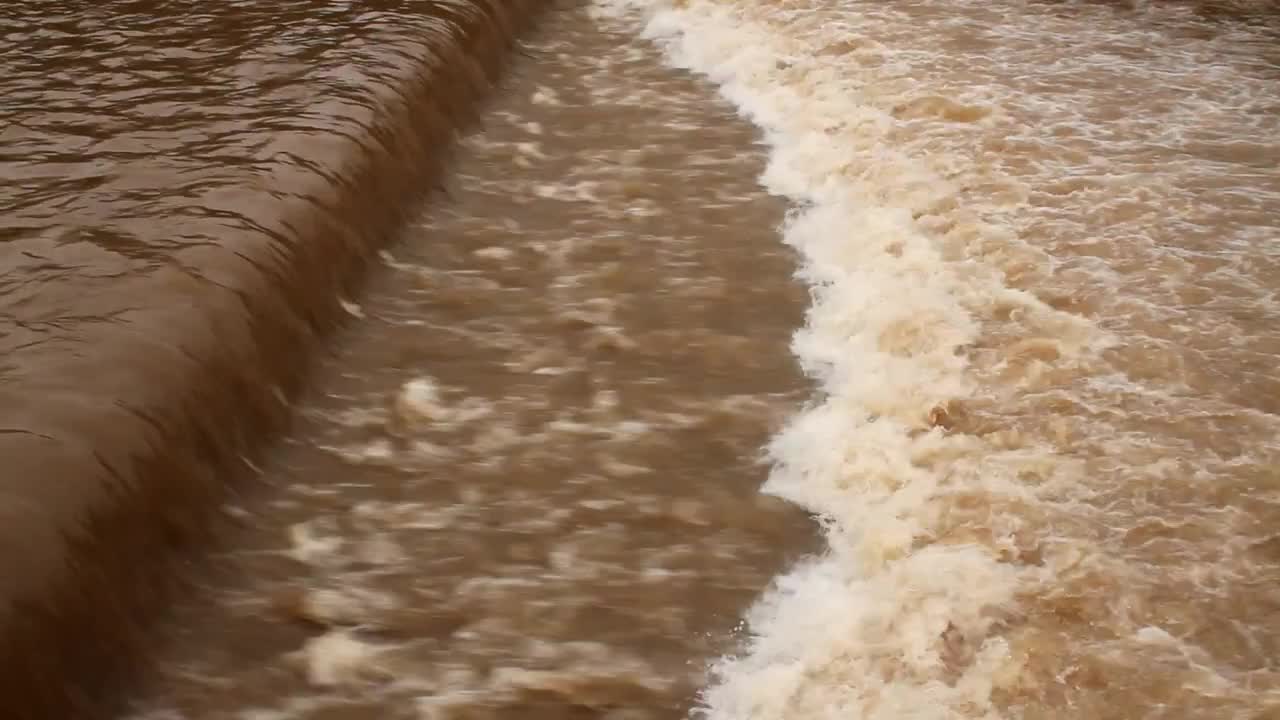 dirty-river-flowing-fast-stock-video-motion-array