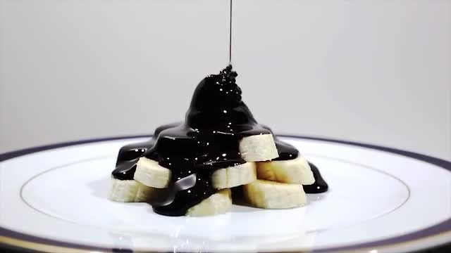 Pouring Black Chocolate On Bananas: Stock Video