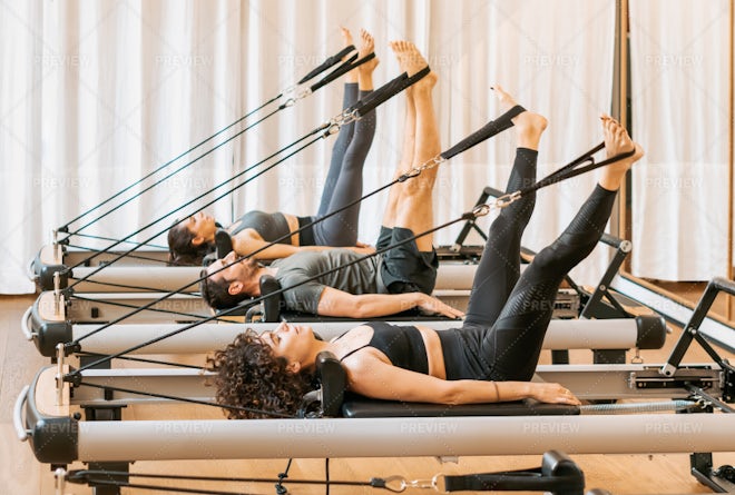 Premium Photo  Man performing triangle pose on pilates reformer bed
