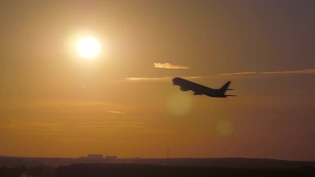 Airplane Takeoff Passing Through Sunset: Stock Video