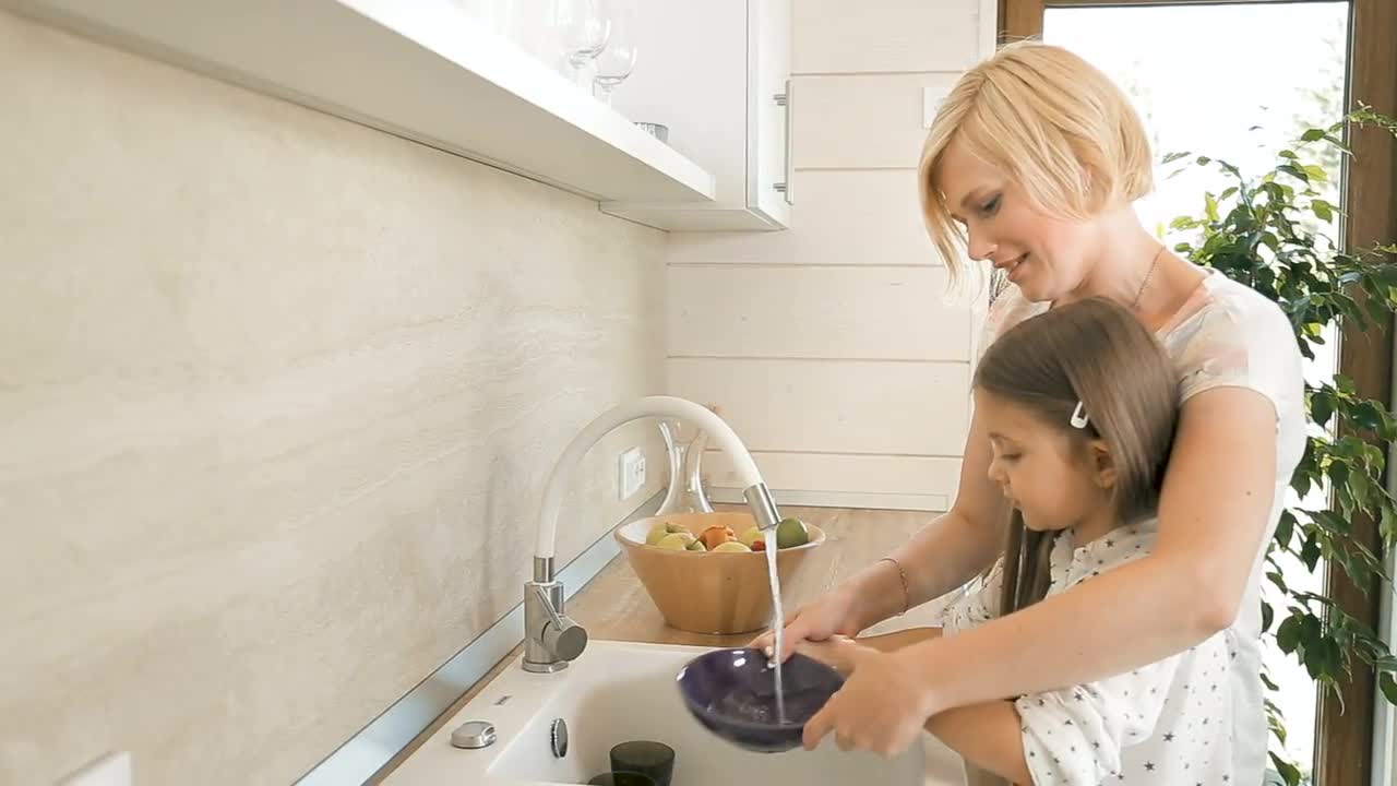 Mom Teaches Her Daughter To Wash Dishes Stock Video Motion Array