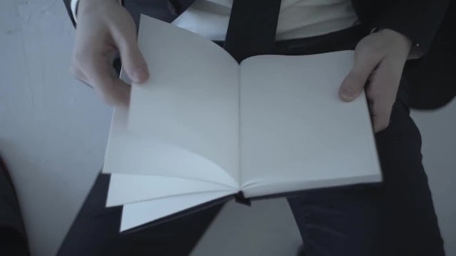 Two hands opening a book with blank page, Stock Video