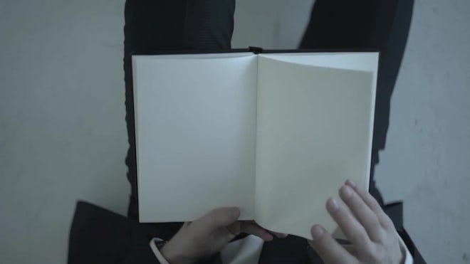 Two hands opening a book with blank page, Stock Video