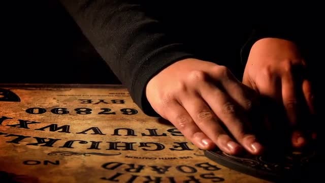 Man Uses Ouija Board: Stock Video