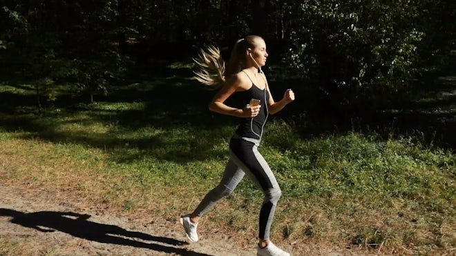 Girl Goes Running In The Park - Stock Video