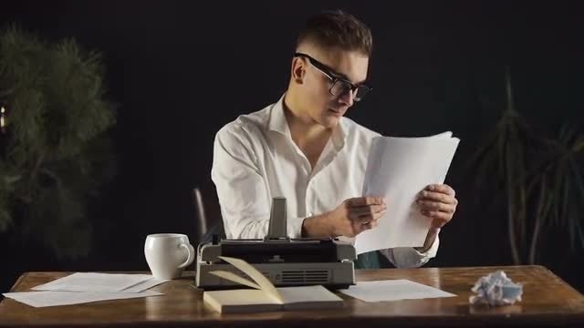 Writer Rereads Typed Pages: Stock Video